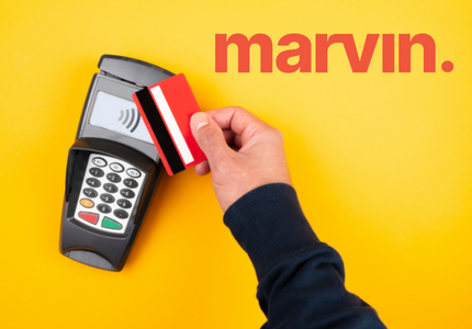 Pessoa passando um cartão numa maquininha de cartão, com o símbolo da Marvin ao lado.