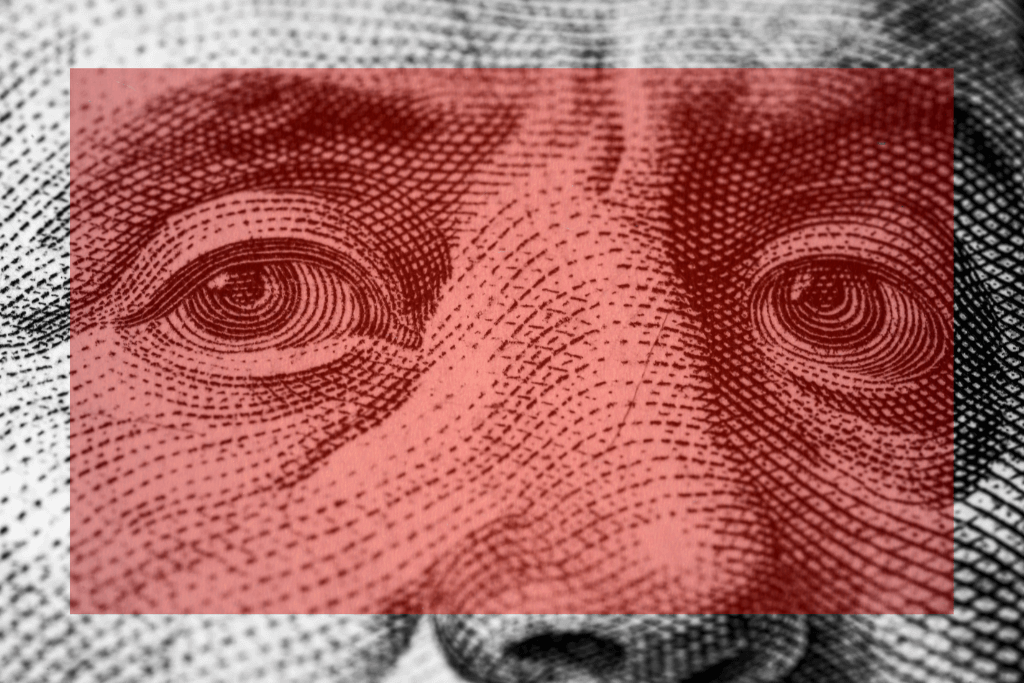 Símbolo da nota de dólar, com quadro vermelho transparente a frente de seu rosto.