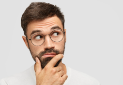 Homem com expressão de dúvida pensando, representando questionamento sobre cancelamento de cartão de crédito